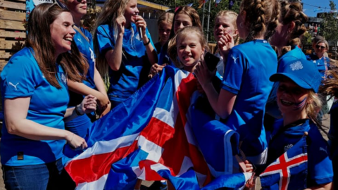 The prime minister of Iceland Katrin Jakobsdottir (left) with Iceland fans before the Euro 2022 game with Belgium in Manchester