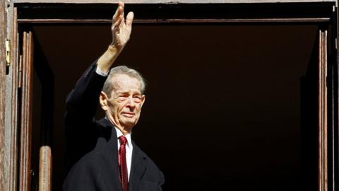 Romania"s former King Michael waves during a ceremony celebrating both his 92nd birthday in 2013