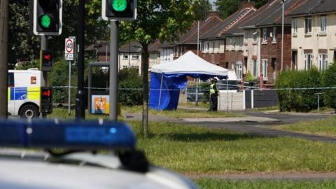 A police forensic tent set up on a street in Rotherham