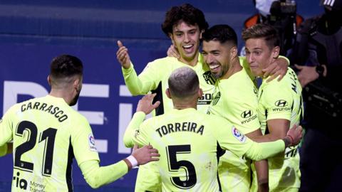 Luis Suarez (second from right) celebrates his winning goal for Atletico against Eibar