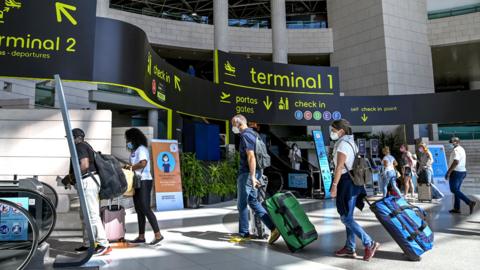 People waiting at Humberto Delgado International Airport in Lisbon