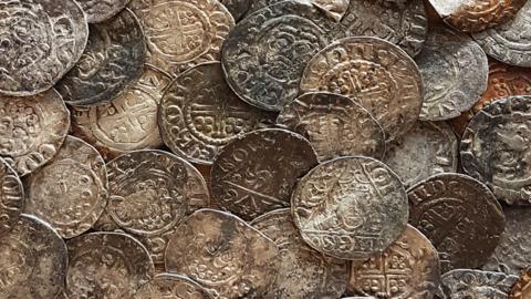 Close up of medieval silver penny hoard