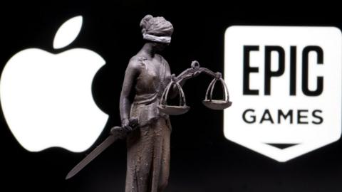 The Apple logo, the Epic logo, and a 3D-printed statue of the personification of Justice with sword and scales between them