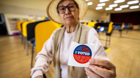 Almaluz Miranda, who has been voting since 1996 since she became a U.S. citizen, of Boyle Heights, shows her vote sticker after she cast her ballot during Super Tuesday primary election at the Boyle Heights Senior Center in Boyle Heights Tuesday, March 5, 2024