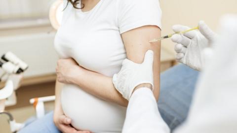 Pregnant woman getting vaccine