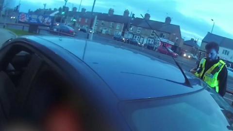 Police officers search a car at a McDonalds drive-through