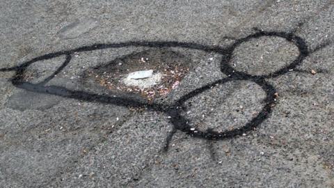 A penis around a pothole