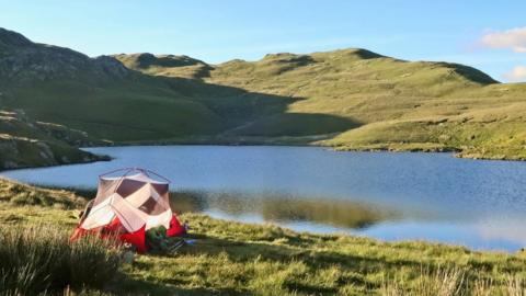 A tent next to a tarn