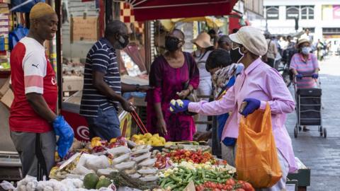 A fruit and vegetable stall trades at Brixton market