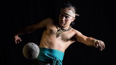 A player of the pre-Columbian ballgame Ulama hits a solid rubber ball with his hip