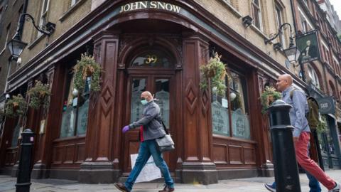 A man walking outside the John Snow pub in central London