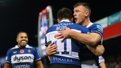 Will Muir is hugged by a team-mate after scoring a try for Bath