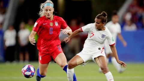 Julie Ertz and Nikita Parris battle for the ball in the USA v England game in 2019