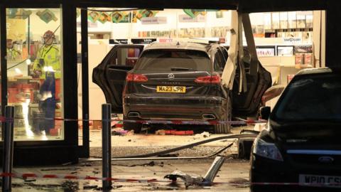 Black Volkswagen crashed through Boots storefront