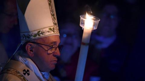 Pope Francis holds a candle during the Easter Vigil mass at the Saint Peter"s Basilica in Vatican City, Vatican, 26 March 2016.