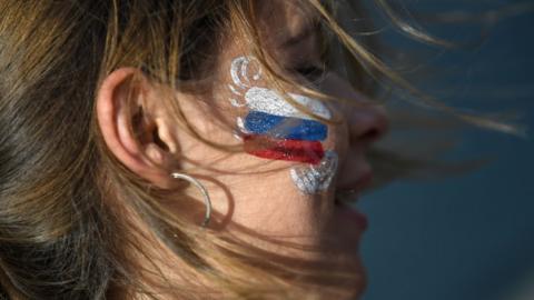 A football fan at the fan zone in Kaliningrad watches Russia vs Egypt