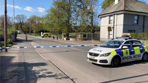 Police car and cordon outside Allerton Grange School