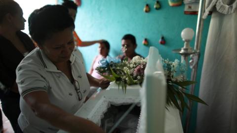 A relative mourns Teiler Lorio Navarrete, a baby killed amid clashes in Managua