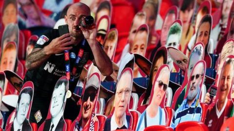 Northampton midfielder Alan McCormack took selfies with some of the cardboard cut-out Cobblers supporters after the game