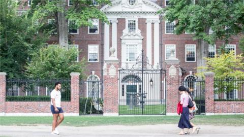 Pedestrians walk past a Harvard University building in August 2018.