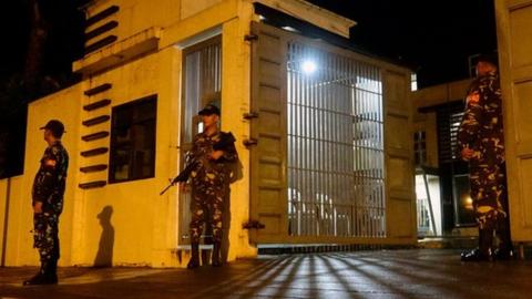 Filipino soldiers stand guard outside a government facility following the declaration of Martial Law