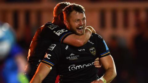 Steff Hughes of Dragons celebrates try with Angus O’Brien