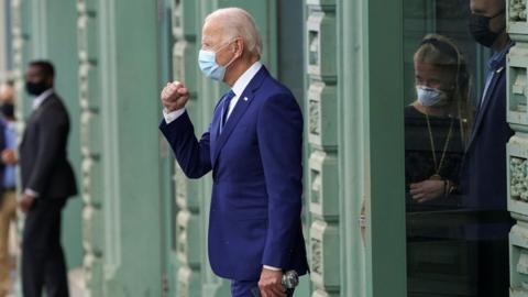 U.S. Democratic presidential candidate Joe Biden pumps his fist to supporters as he walks to his motorcade vehicle in downtown Wilmington, Delaware, U.S., October 23, 2020