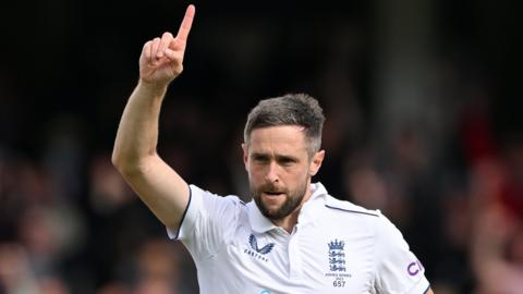 England's Chris Woakes celebrates taking an Australia wicket