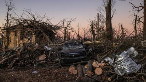 A destroyed vehicle sits in the aftermath of a tornado in Mayfield, Kentucky, 13 December 2021