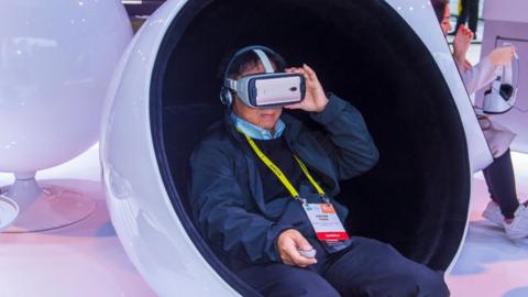 Man wearing VR headset at a trade show