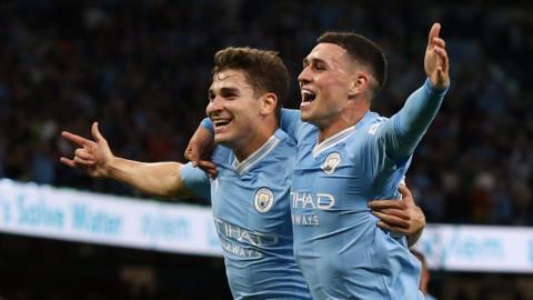 Julian Alvarez celebrates with Phil Foden after putting Manchester City 1-0 up