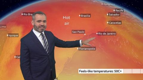 Ben Rich in front of a weather map of Brazil showing high temperatures