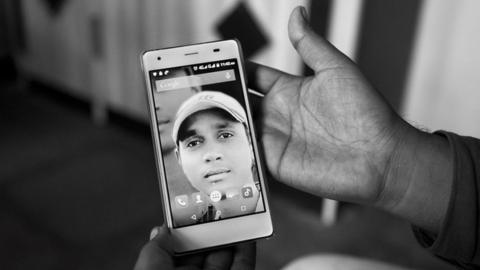 A family member holding Sagar Shejwal’s photo.