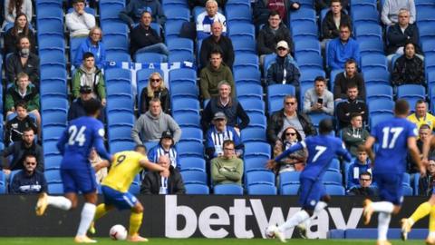 Fans watch the Brighton v Chelsea test match