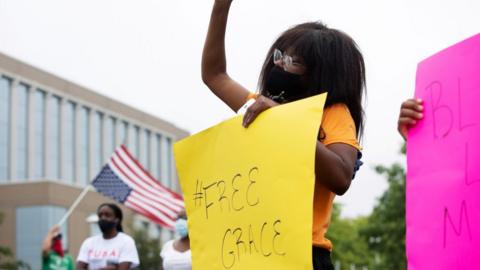 People protest in support of an African-American student who was jailed due to a probation violation of not keeping up with her online schoolwork