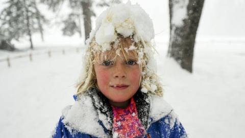 A child enjoys the snow in Yosemite National Park