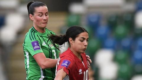 Maria Farrugia of Malta is challenged by Demi Vance of Northern Ireland