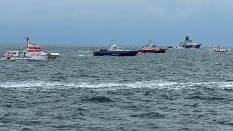 German rescue ships are seen in search for survivors following the collision of two freighter ships, the British-flagged vessel Verity and the Bahamas-flagged freighter Polesie, in the German North Sea