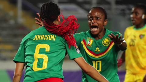 Cameroon players celebrate a goal