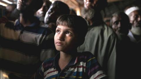 Rohingya refugees watch ICJ proceedings at a restaurant in a refugee camp