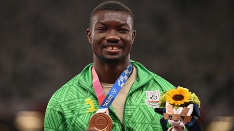 Burkina Faso's Hugues Fabrice Zango with his Olympic triple jump bronze medal