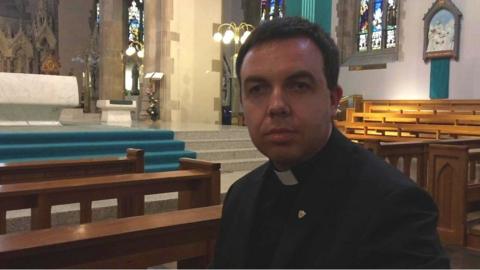 Father Patrick Lagan preparing for mass.