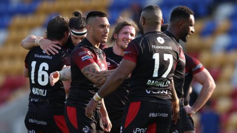 London Broncos players celebrate a try against Toulouse