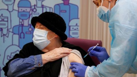 A woman receives the Pfizer-BioNTech vaccine in Lleida, Spain, December 27, 2020