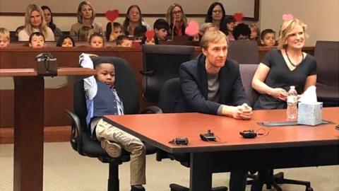 A picture shared by Kent County, Michigan's Facebook page shows a little boy named Michael being formally adopted in court, watched by his Kindergarten classmates