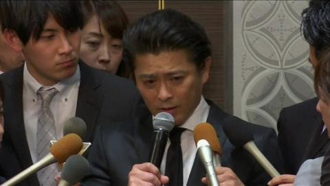 Tatsuya Yamaguchi speaks into a microphone at a press conference in Japan