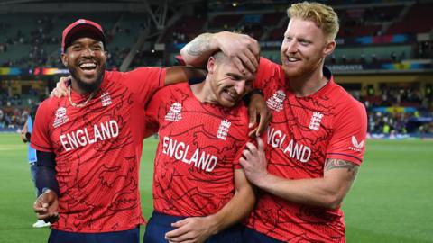 England captain Jos Buttler celebrates with Ben Stokes and Chris Jordan