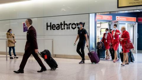 Passengers arrive at Heathrow Airport just in time for Christmas in a few days on December 22, 2020 in London