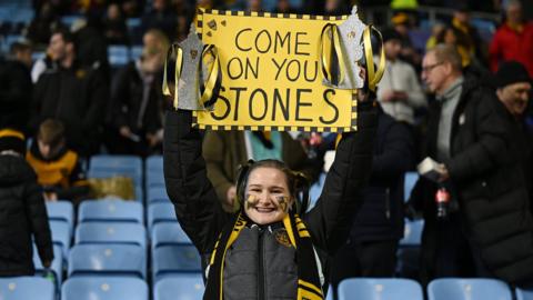 A Maidstone United fan supports the team at Coventry City