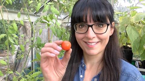 Ellen Mary holding a tomato